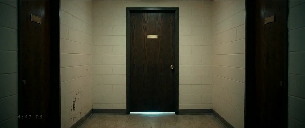 His dorm door in the corridor, light showing underneath, timestamp 4:47 PM