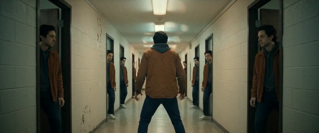 Eli from behind in the corridor as every door opens on another Eli